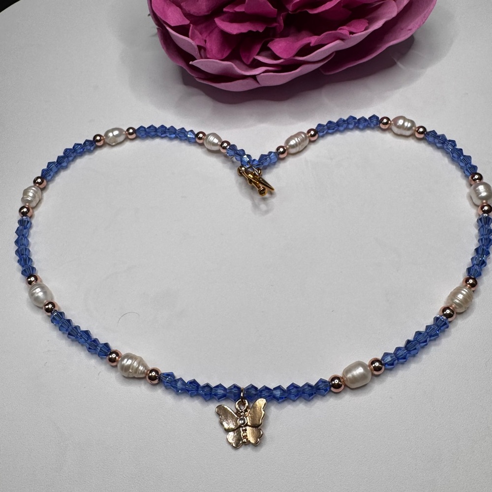 Elegant Blue Beaded Necklace with Gold Butterfly Pendant